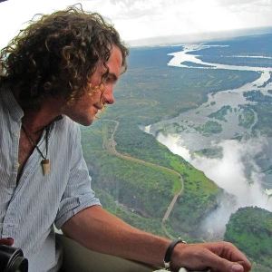 Passenger looking over the Zambezi River during a helicopter flight